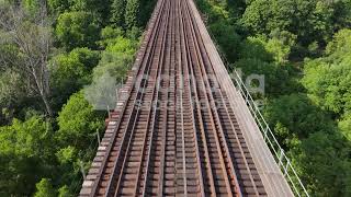 Drone following train tracks on top of trestle bridge stock video. Toronto. 4K.