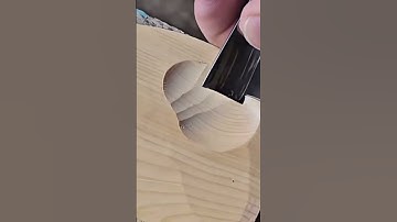 Carving a wooden surface using a sharp chisel tool