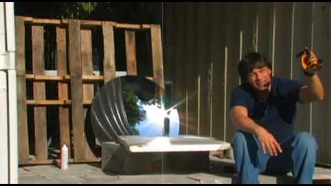 PARABOLIC MIRROR concentrated sunlight on an evacuated solar tube boiling water with the Sun