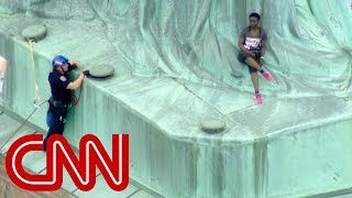 Protester climbs Statue of Liberty