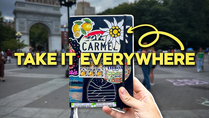 A hand holding a decorated notebook featuring various stickers, including one that says "CARMEL," against the backdrop of a park with people and an archway in the distance. The text "TAKE IT EVERYWHERE" is prominently displayed in yellow.