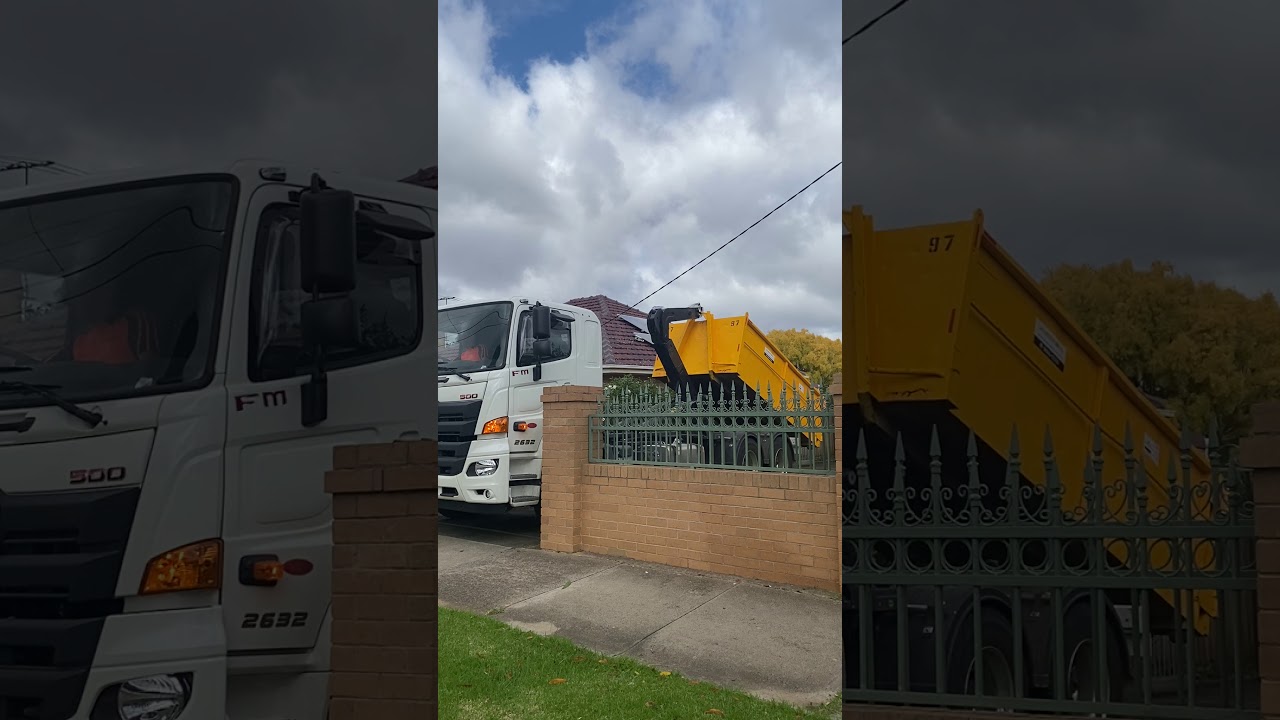 Hino Hook Lift Truck unloads skip bin