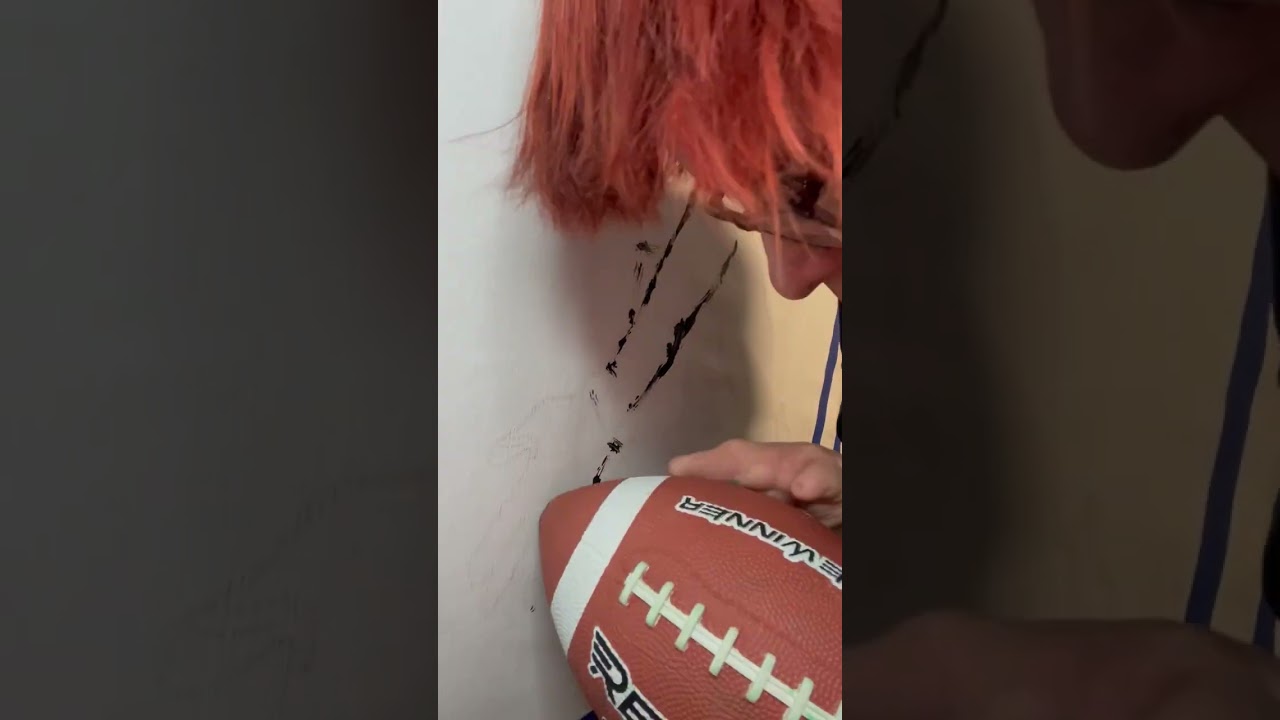 Painting J.J. Watt with a football as a paintbrush.