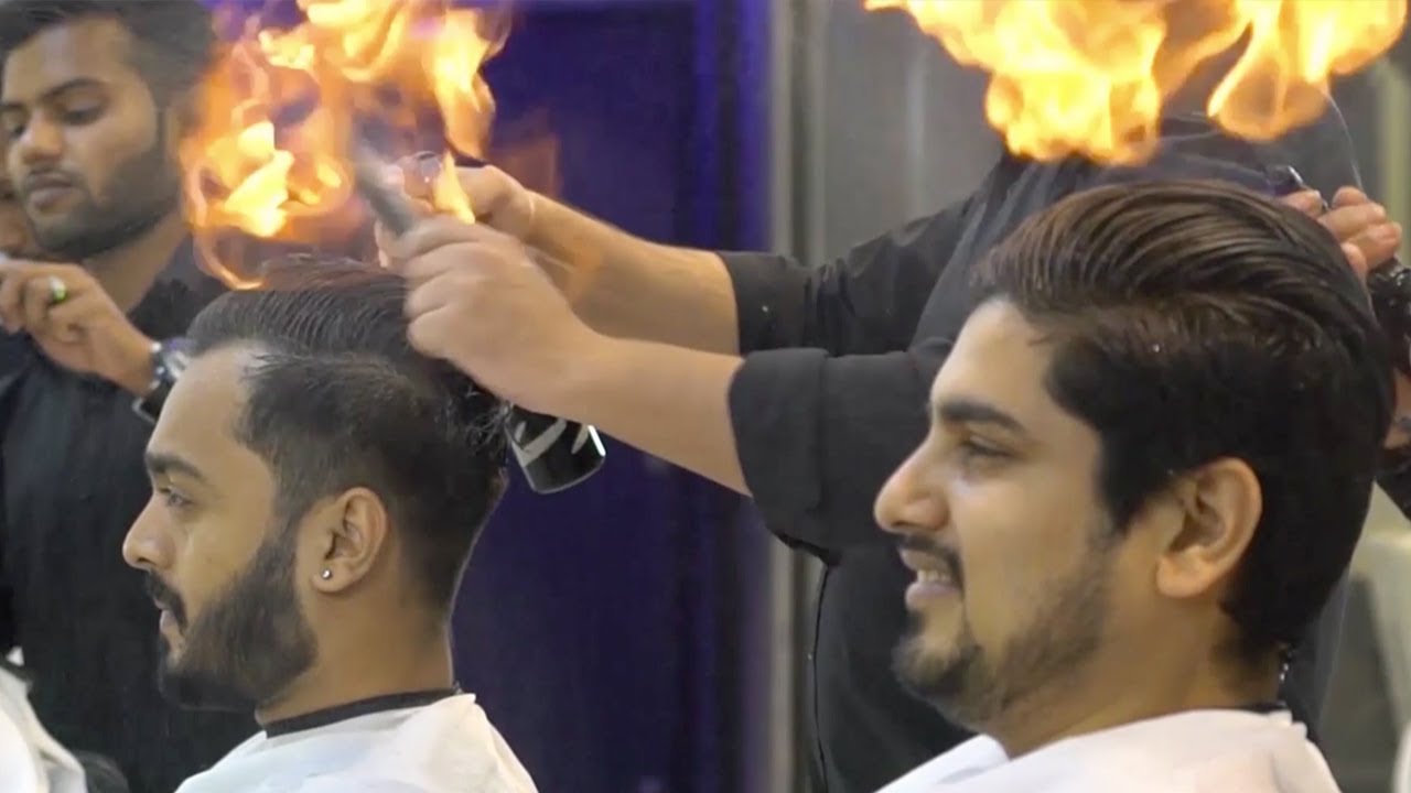 Indian barber cuts mens hair by setting it on fire