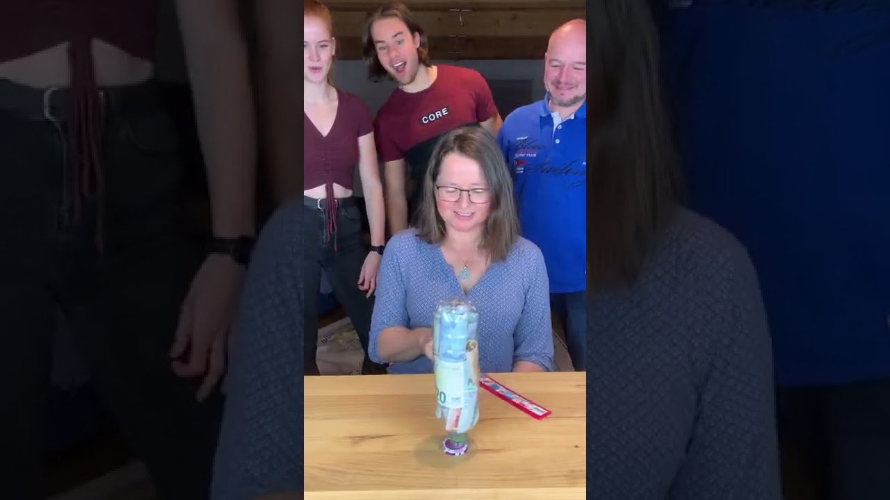 People are playing a game with poker chips and a bottle!