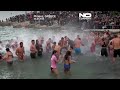 Young men in Greece dive for wooden cross in Epiphany celebration