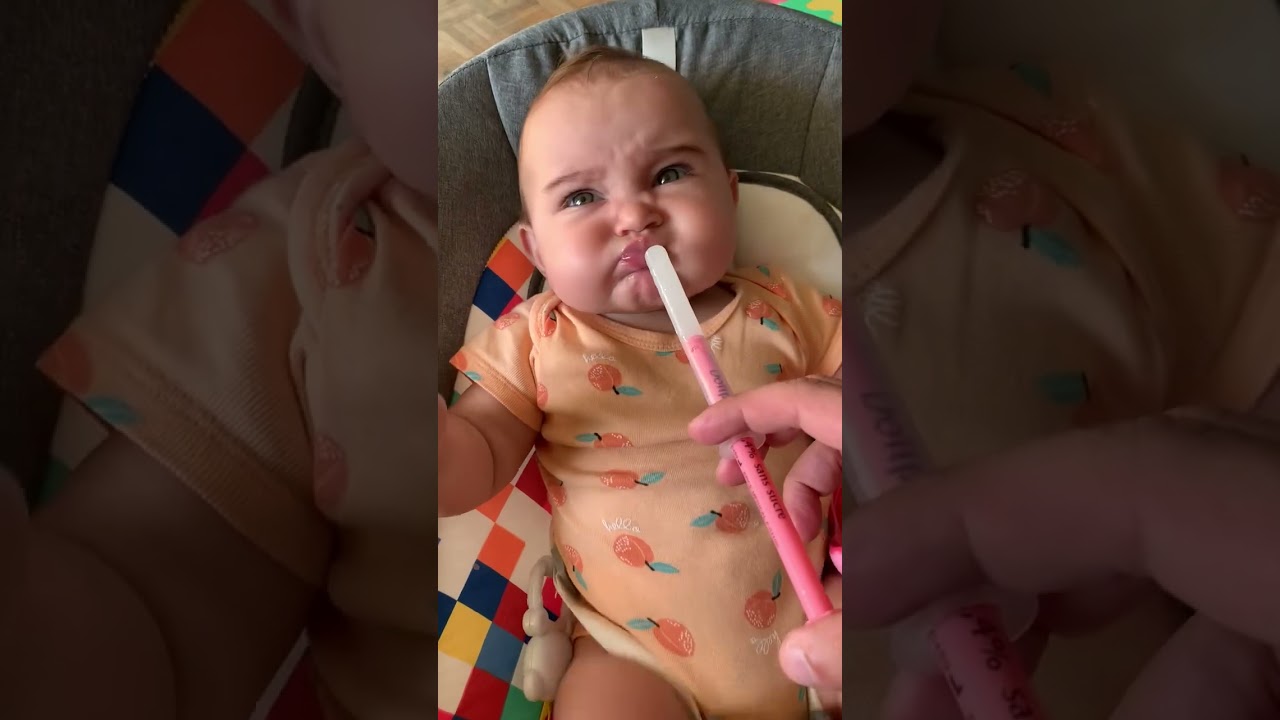 Baby expresses her dislike for toothache medicine