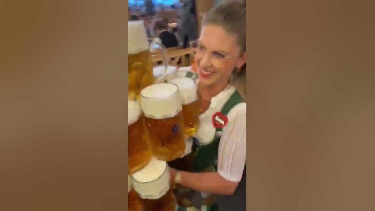 oktoberfest waitress carries 13 beer mugs