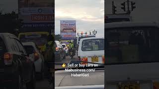 Traffic lights at Patel's roundabout Kisumu in the evening (Suzuki, Subaru and Toyota vehicles)