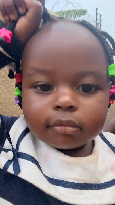 Baby holding tight her hair