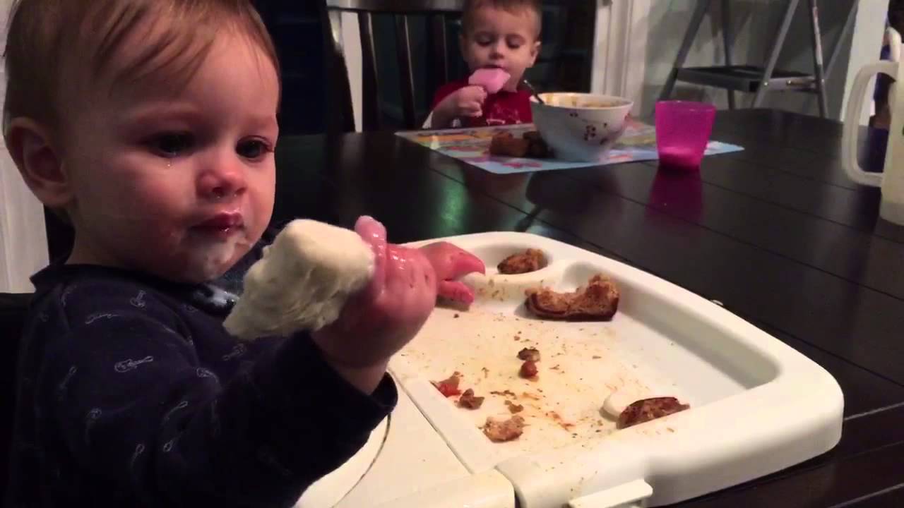 Baby girl toddler ice cream headache, continues to eat ice cream0