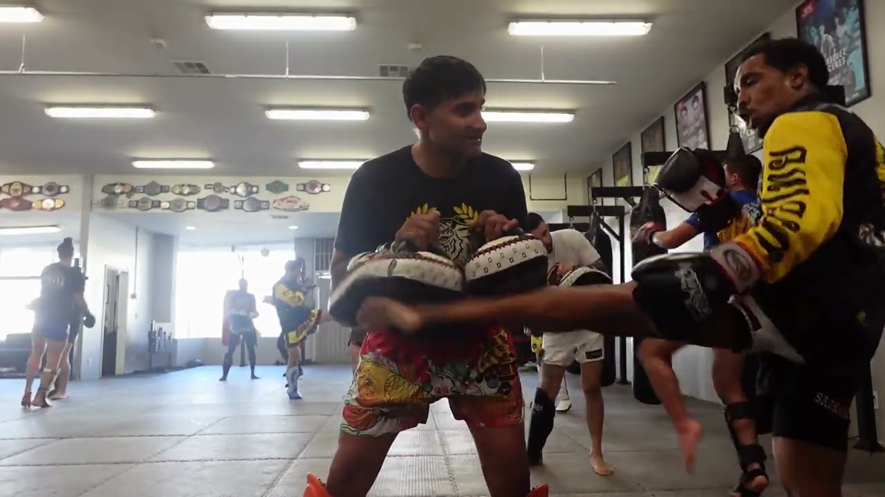 Muay Thai Mondays holding pads for Kicks