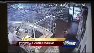 Caught On Video: Armed man in black robs pharmacy