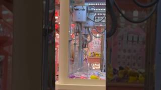 Winning a cinnamon roll keychain from the claw machine!