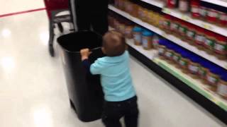 Little Alan pushing a trash can at Target!!