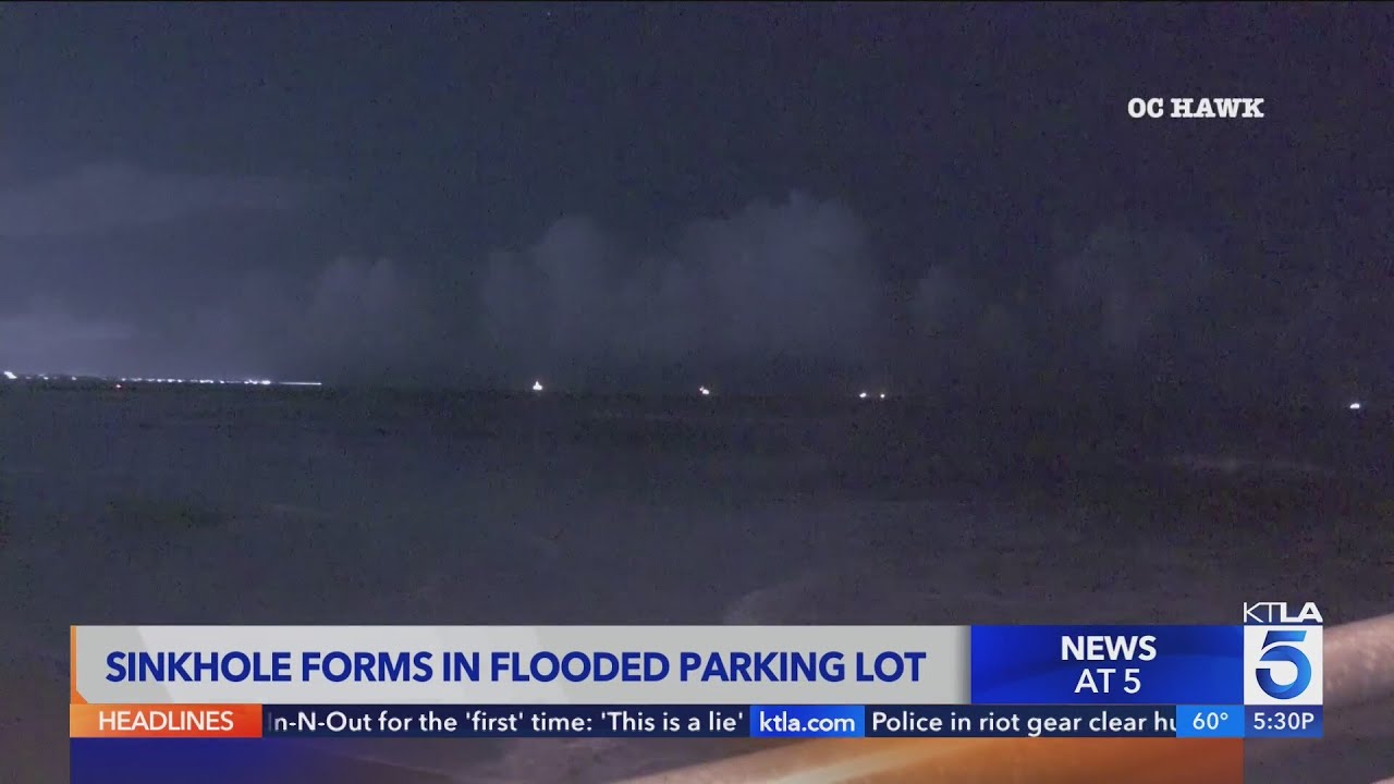 Sinkhole forms in flooded Seal Beach parking lot - YouTube