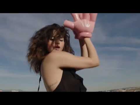 Selena Gomez behind