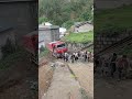 Villagers Pulling a Truck Uphill Using Ropes