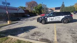 Woodridge PD surround car, take handcuffed man away at Downers Grove Walgreens 63rd and Belmont.