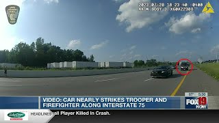 VIDEO: Car nearly strikes trooper, firefighter along I-75
