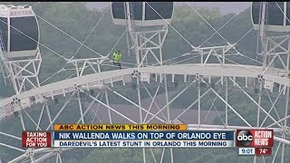 Sarasota daredevil Nik Wallenda walks atop giant ferris wheel, Orlando Eye, while it's moving