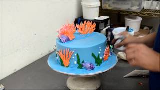 Making of a little ariel theme cake with ocean sea shell design
flowers made from white chocolate cream and grass that's painted green
butter ...
