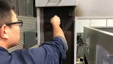 Re-threading wire on medium-speed wire cut EDM machine.