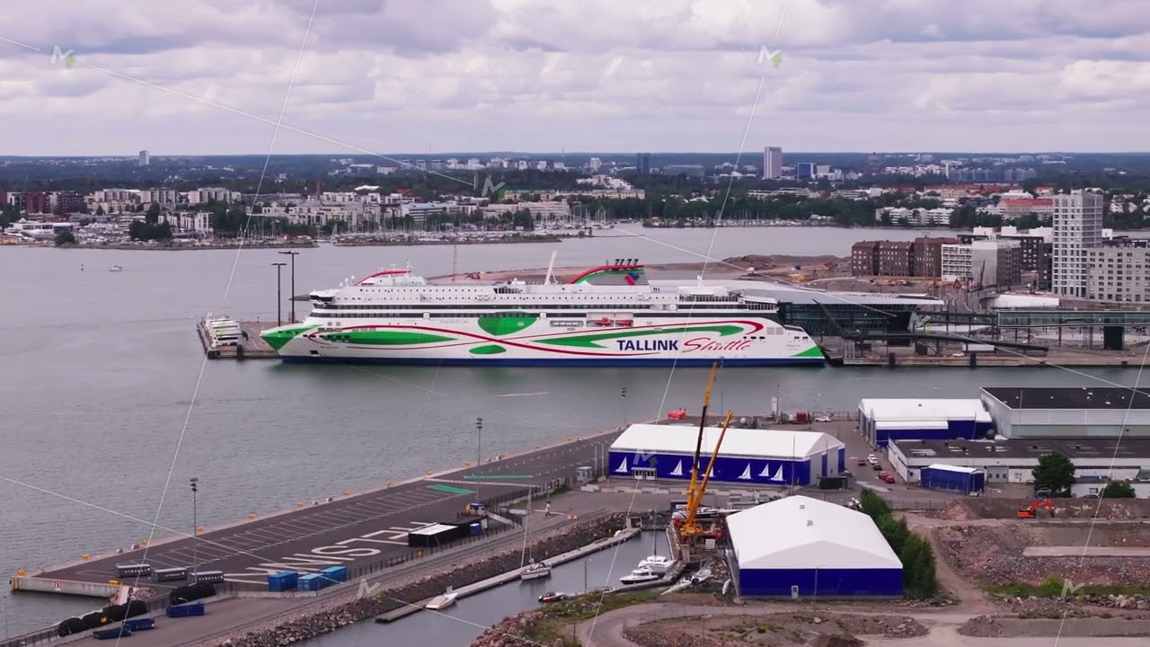 Aerial footage of small motorboat passing along big cruise ferry waiting in harbour. Transportation