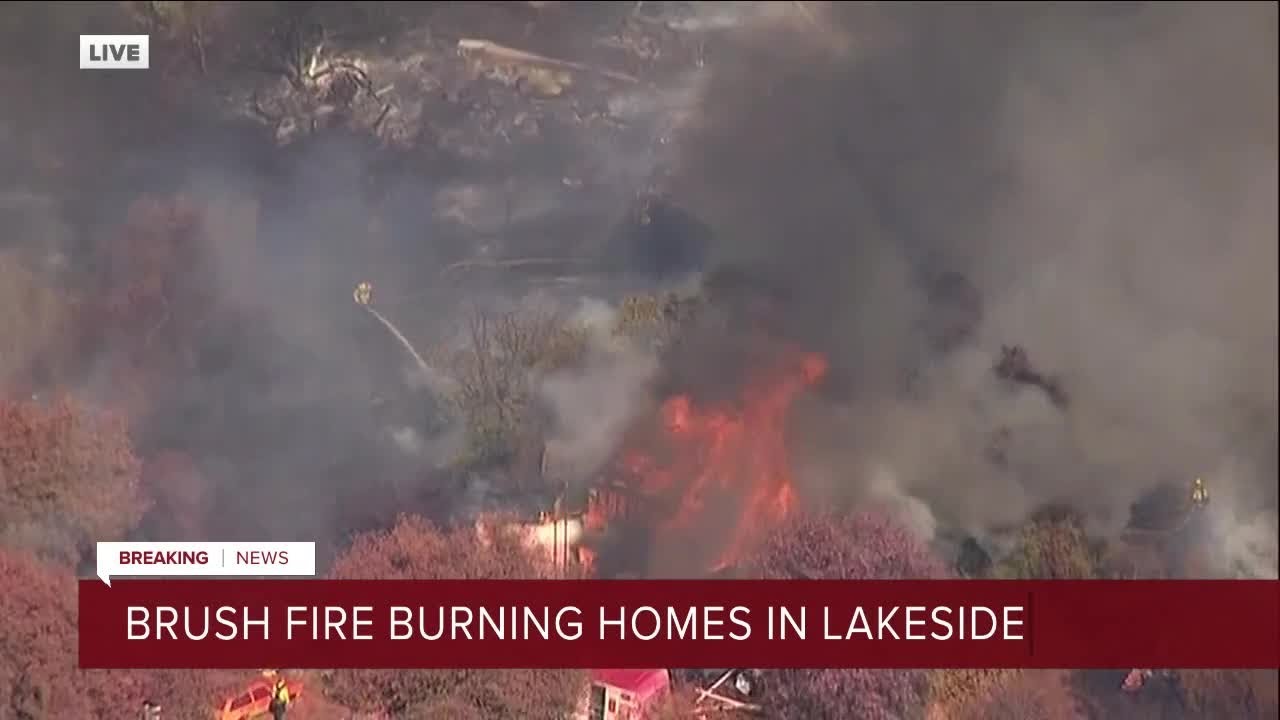 Brush fire burning homes in Lakeside