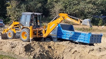 Escorts Backhoe Loader Cutting Soil and Loading in Dump Truck - Dozer Video
