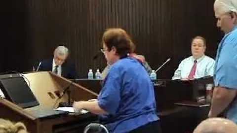 APRIL HUBER STANDS UP AGAINST THE UN FLAG BLOOMING...