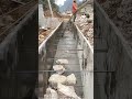 Long Trench Construction: Workers and Machinery Collaborate in Concrete Pouring