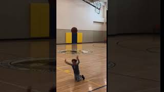 Kid slips in the gym while playing basketball