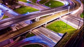 night timelapse aerial view of a freeway intersection traffic trails in night moscow