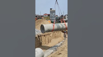 Mobile crane install concrete pipe for drainage system