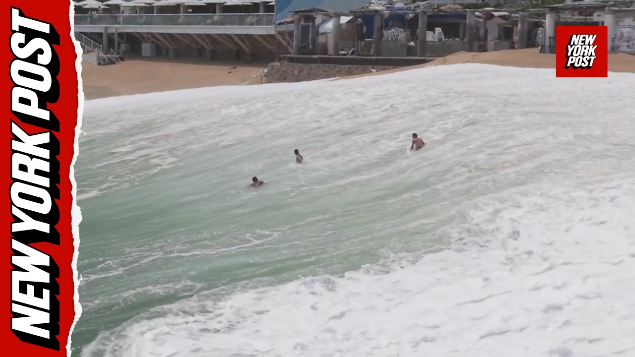 Drone video captures moment giant wave swallows up swimmers on Mexican beach