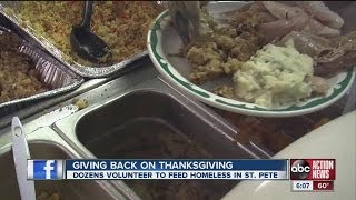 Volunteers help feed homemade turkey dinners for hundreds of homeless, needy