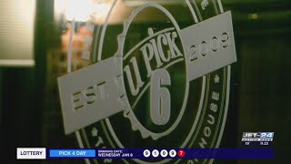 Members of Lake Erie Ale Trail raise a glass to recognize their founder