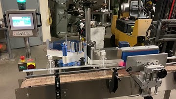 LabelOn Pressure Sensitive Labeler with Wrap Station & Conveyor running 16oz round