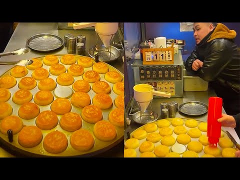 Cooking fried hamburgers with meat abd eggs fillings. Street foid.