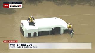 Two People On Top of Van Rescued From High Water