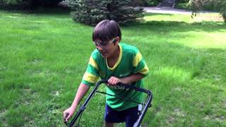 First & Last Time smiling mowing the lawn.