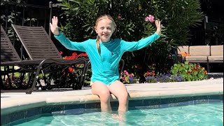 Alissa swimming in the pool during vacation. Kids vlog.