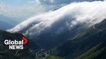 "River of clouds" descends over Swiss Alps in stunning drone video