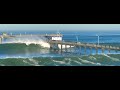 Waves destroy ob pier and take down surfer