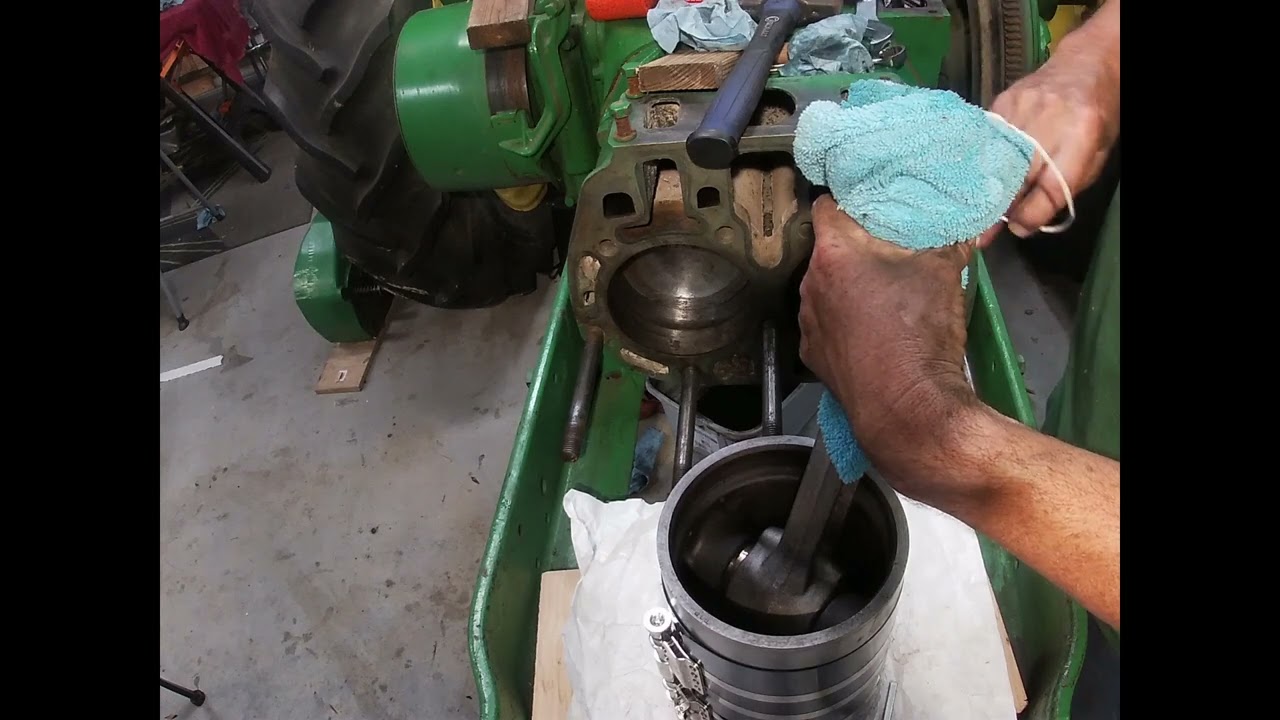 Piston install to Engine block of a John Deere 2 cylinder engine.