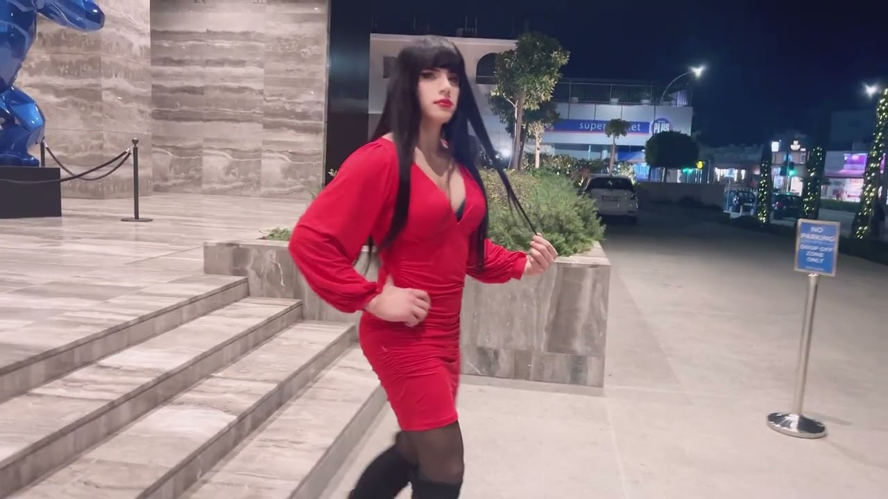 Crossdresser red dress outdoors