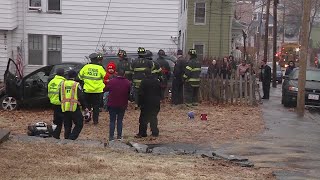 Car Slides Off Icy Road, Comes To Rest On Retaining Wall