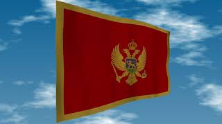 モンテネグロの国旗　背景の空には雲が流れています。 Flag of Montenegro. Clouds are flowing in the background.