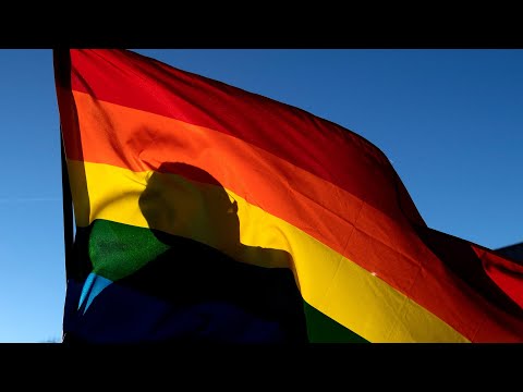 Watch: ‘sacred cloth’ pride flag unfurled at colorado springs city hall after shooting